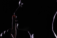 A silhouette of a person with their index finger at their lips indicating quiet.